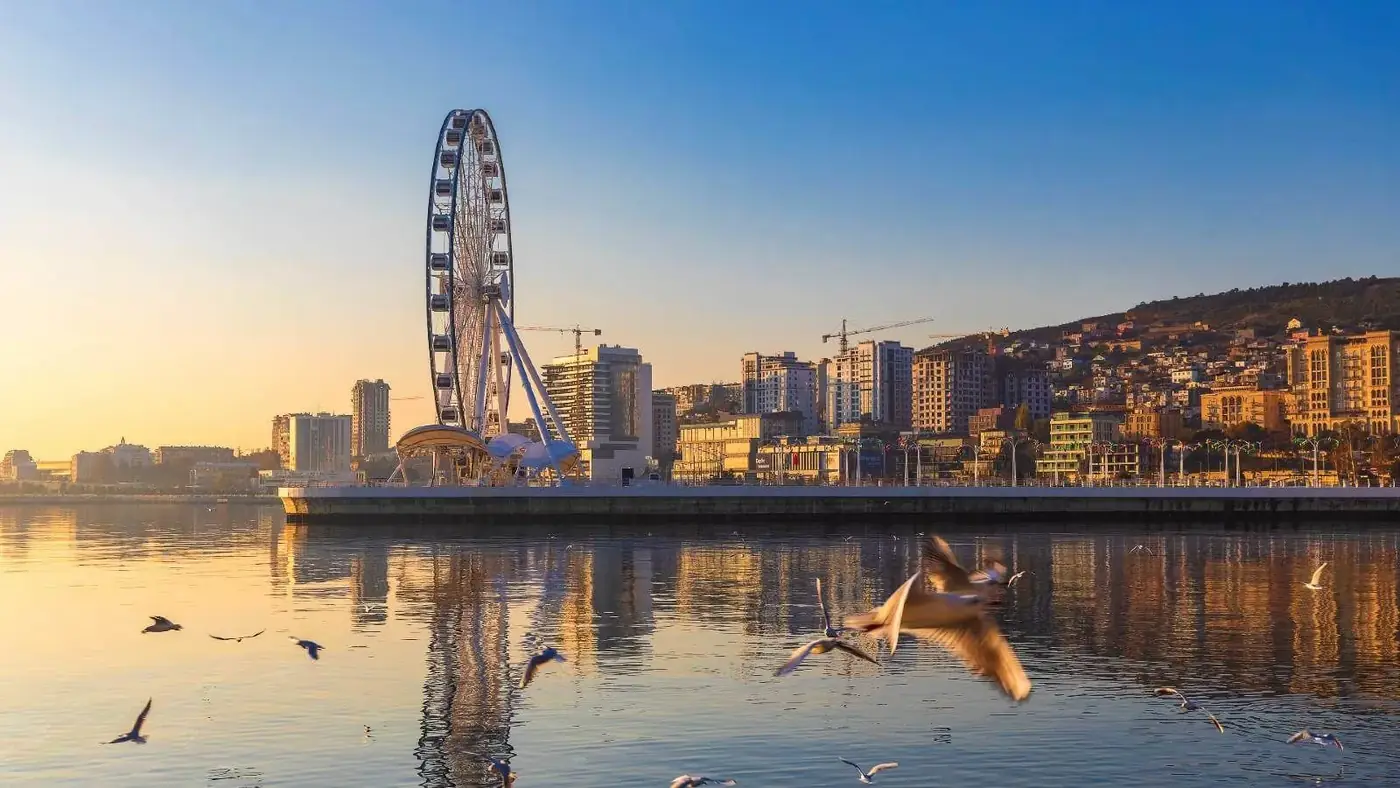 The Baku Eye Ferris wheel and Caspian seafront at sunset in Baku, Azerbaijan